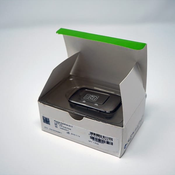Phonak compilot air box with the product inside on a white background