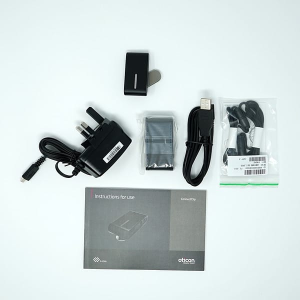 Image of Oticon Phone Clip 1 product on white background with manual and cables