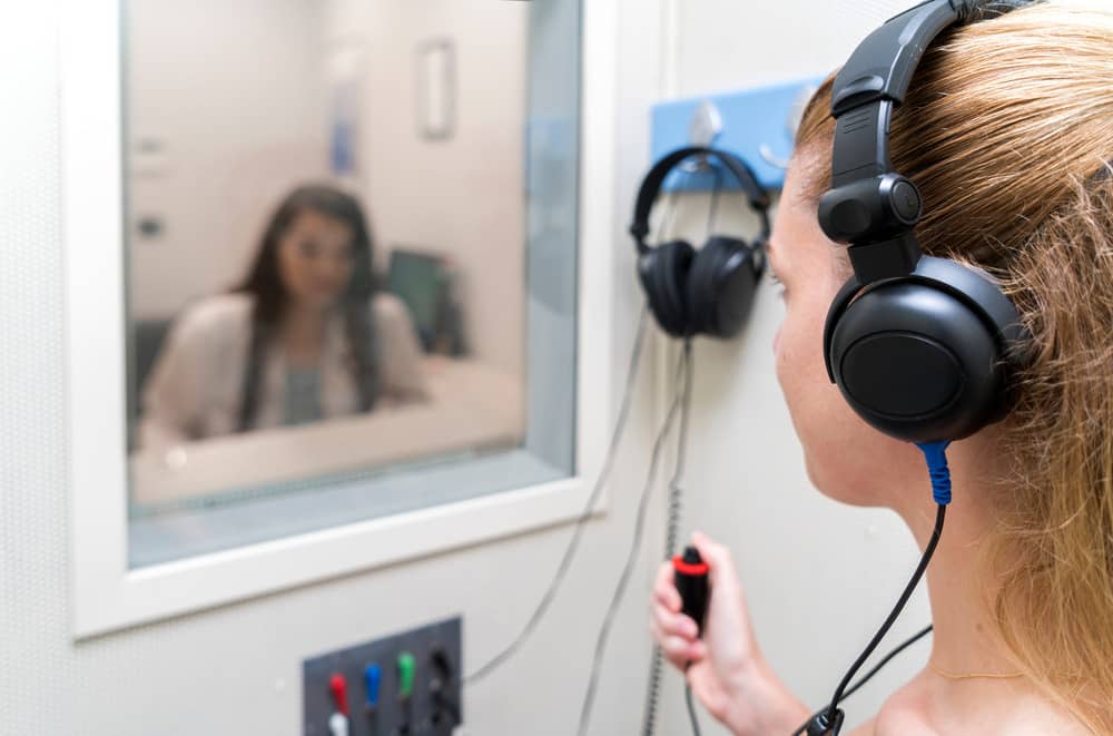 Young woman undergoing a hearing test.
