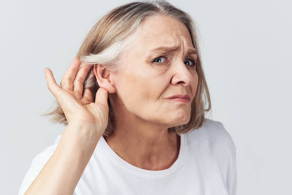 Senior woman struggling to hear