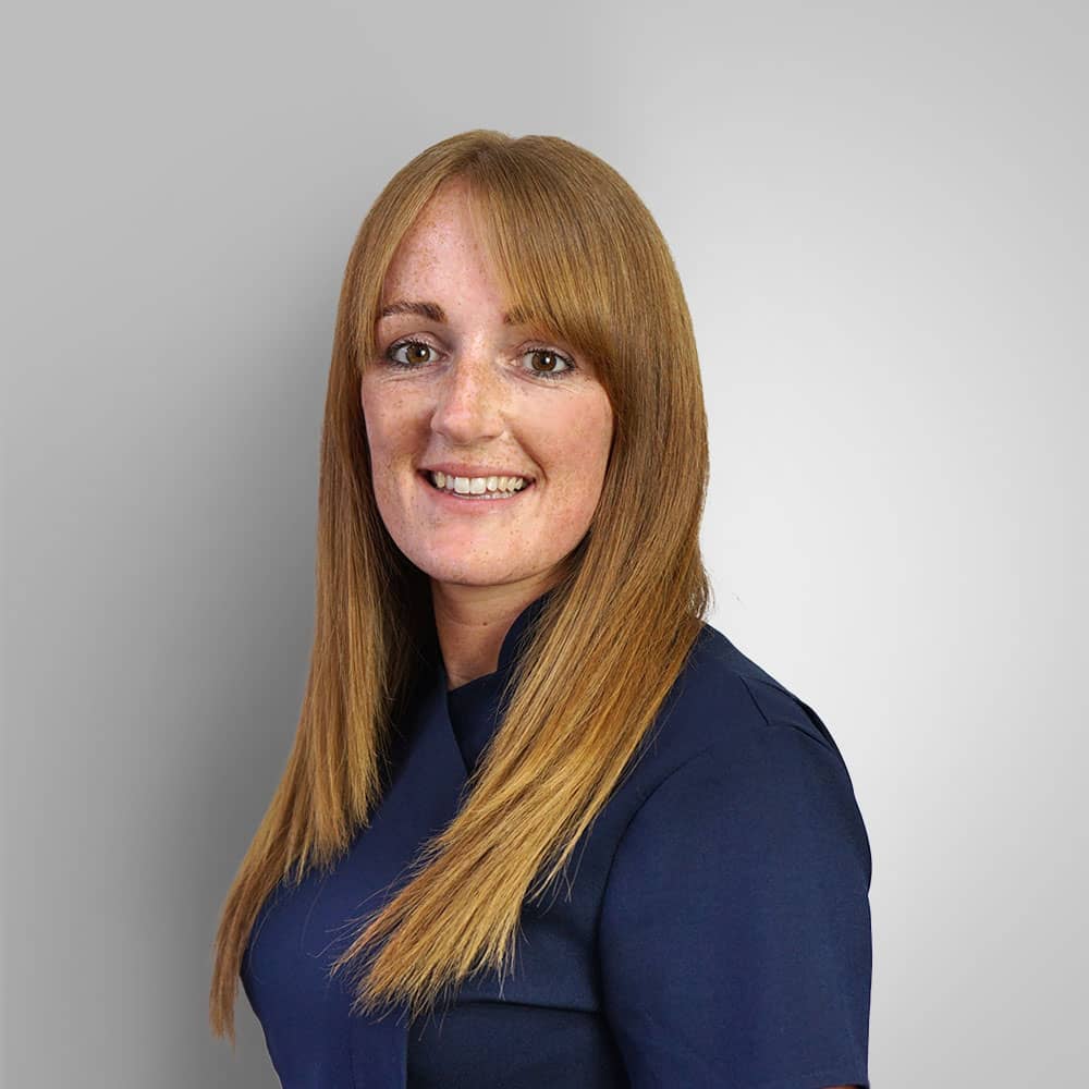 Photograph of Hear4u head receptionist (Debbie) wearing navy uniform with long ginger hair