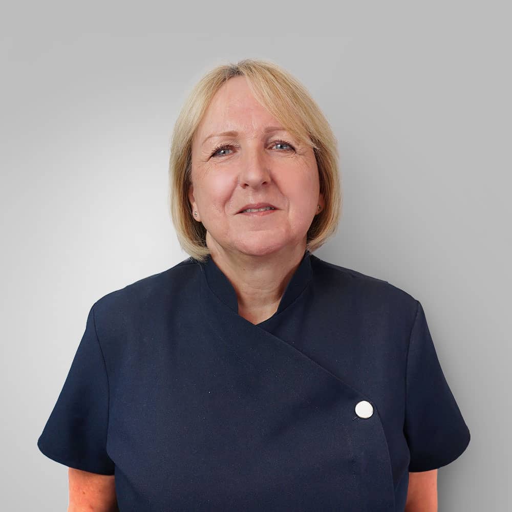 Photo of blond short hair receptionist (Beverly) on grey background