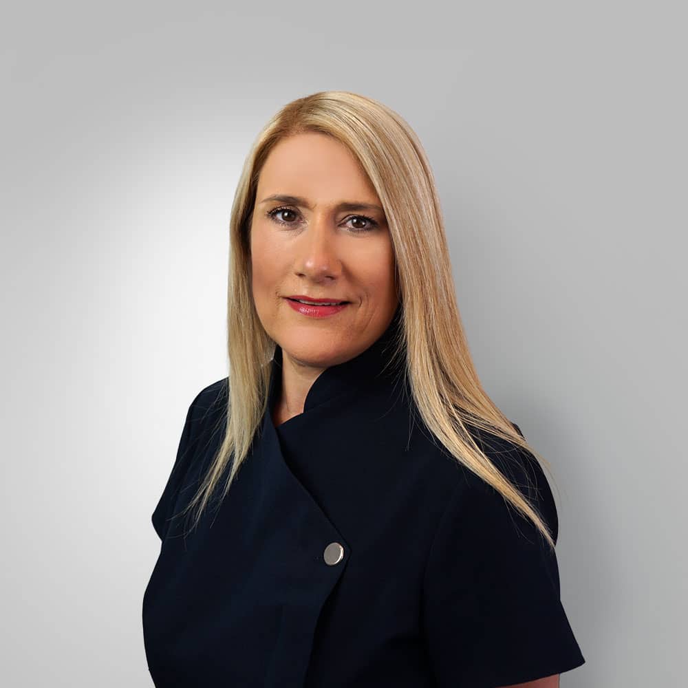 Photograph of blond receptionist (Sophie) against grey background