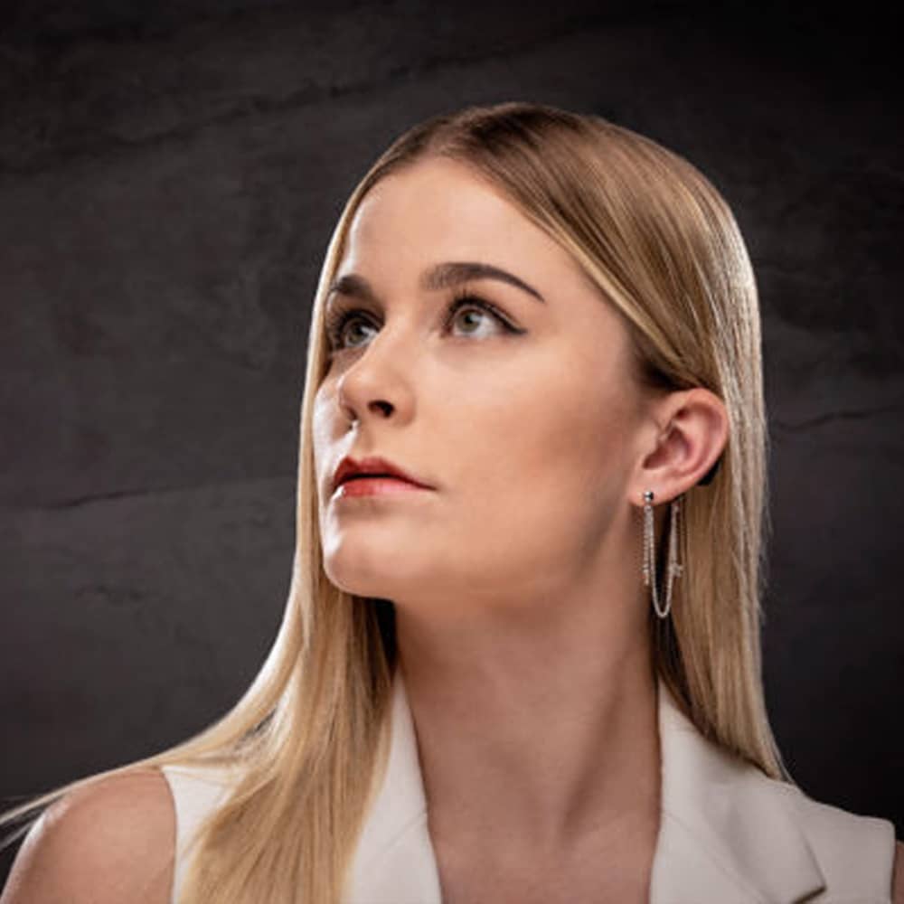 woman modelling deafmetal riley star hearing aid jewellery