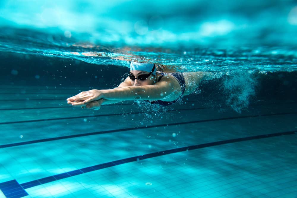 Swimmer using swim plugs