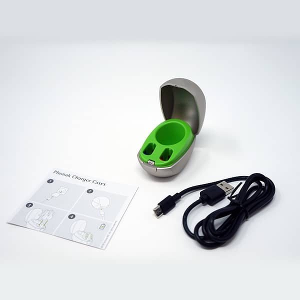 Phonak mini charger displaying contents of the package on which background with charger, manual and cable