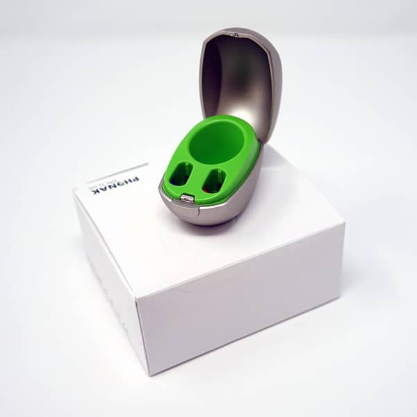 Phonak mini charger sat ontop of box on white background
