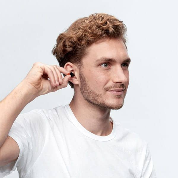 Young man inserting WorkSafe Earplugs into his ears