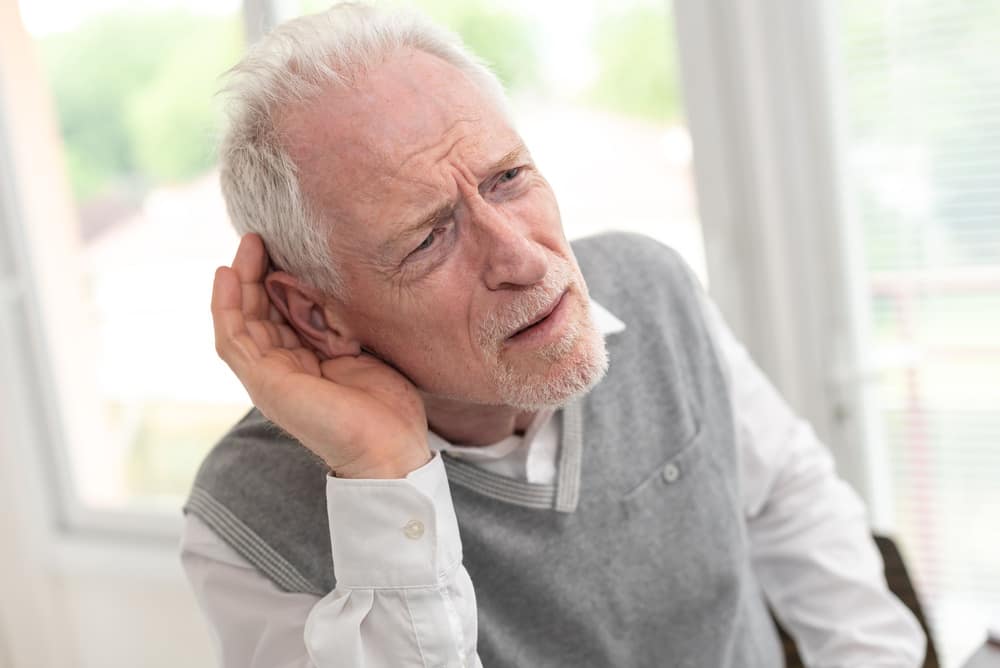 Elderly man struggling to hear.